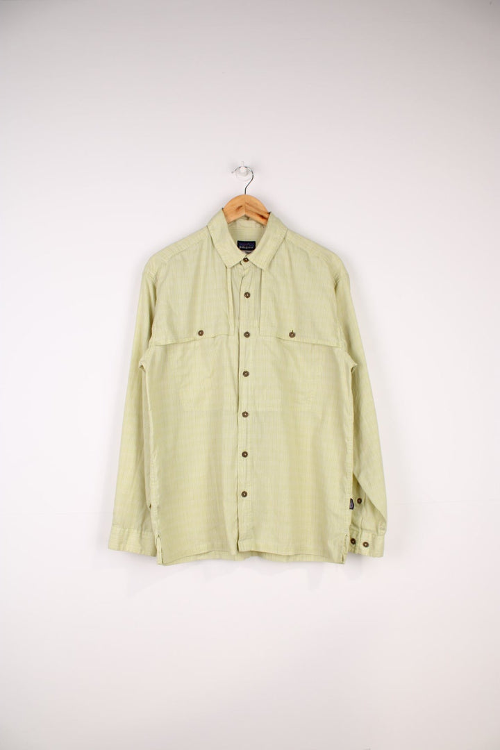 Patagonia Vented Shirt in a green checkered colourway, button up with double chest pockets which overlaps as an air vent, also has the logo embroidered on the side.