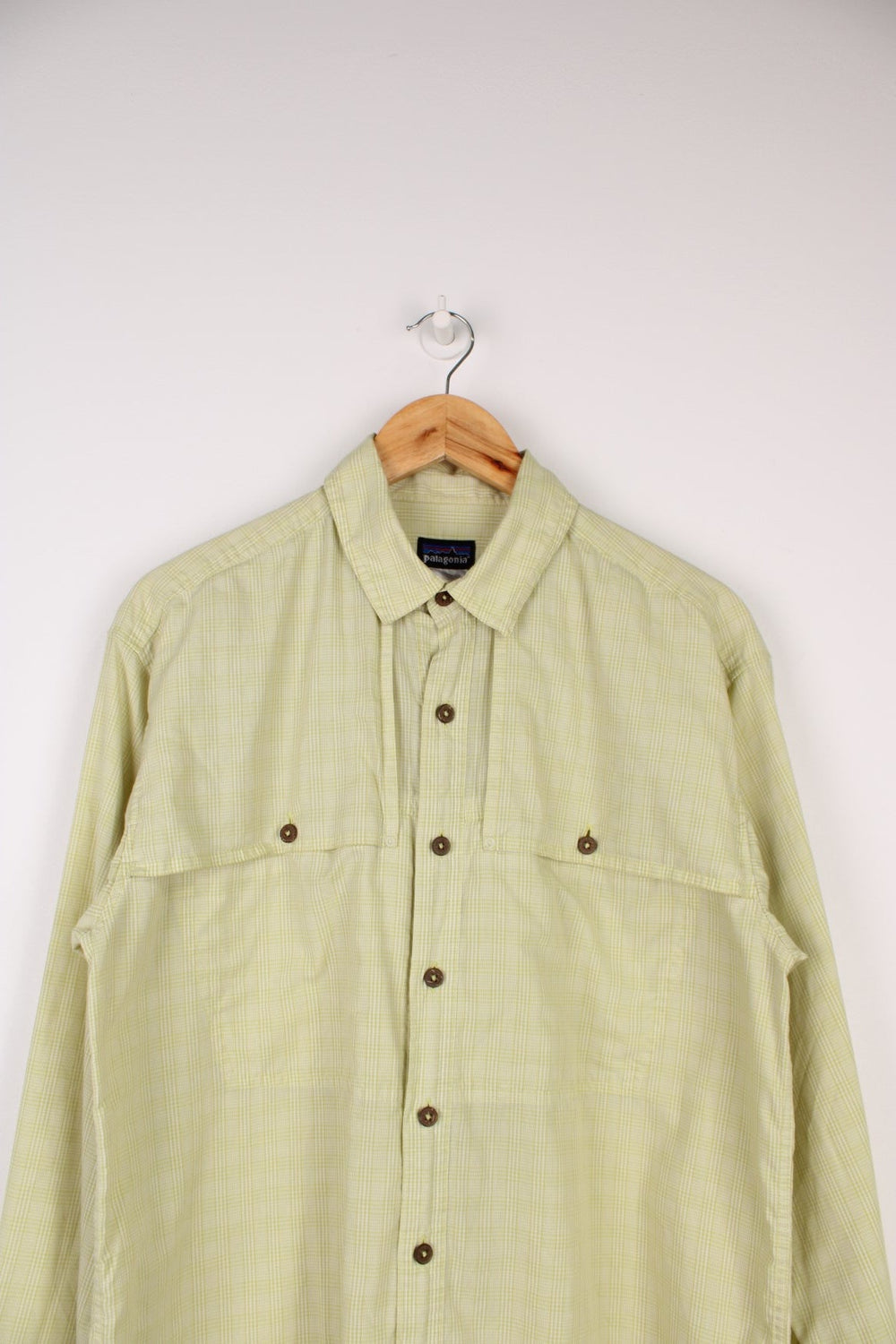 Patagonia Vented Shirt in a green checkered colourway, button up with double chest pockets which overlaps as an air vent, also has the logo embroidered on the side.