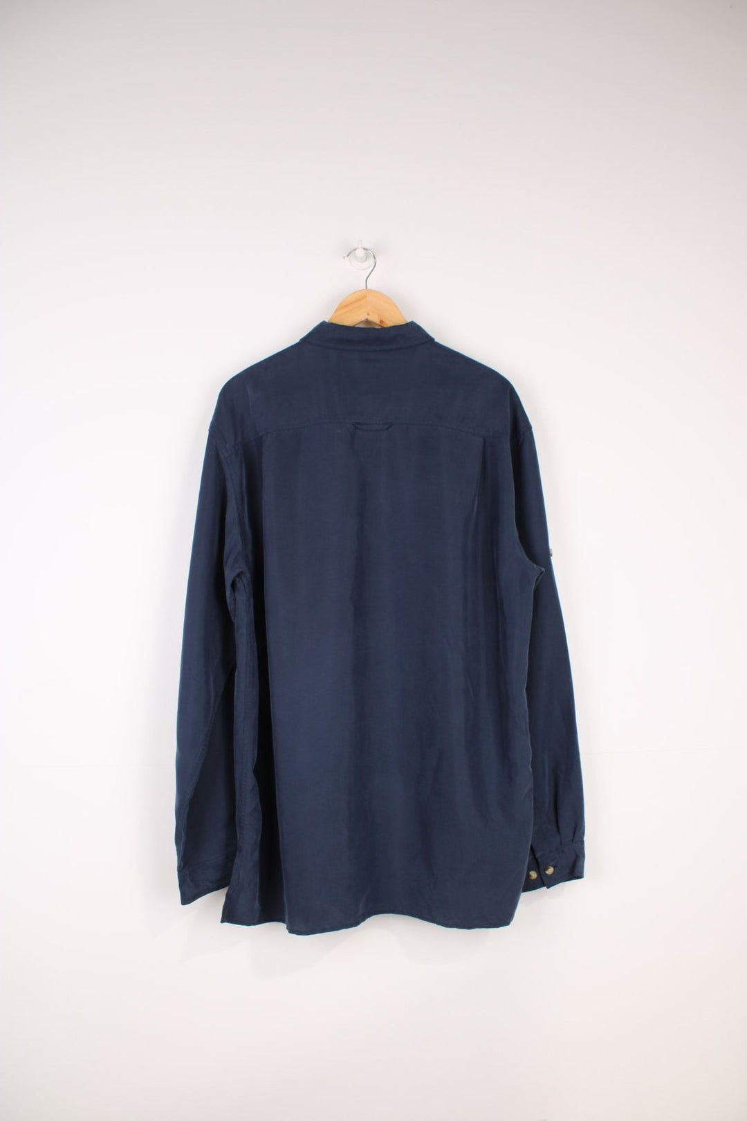 The North Face Long Sleeved Shirt in a navy blue colourway, button up and has a chest pocket with the logo embroidered on it.