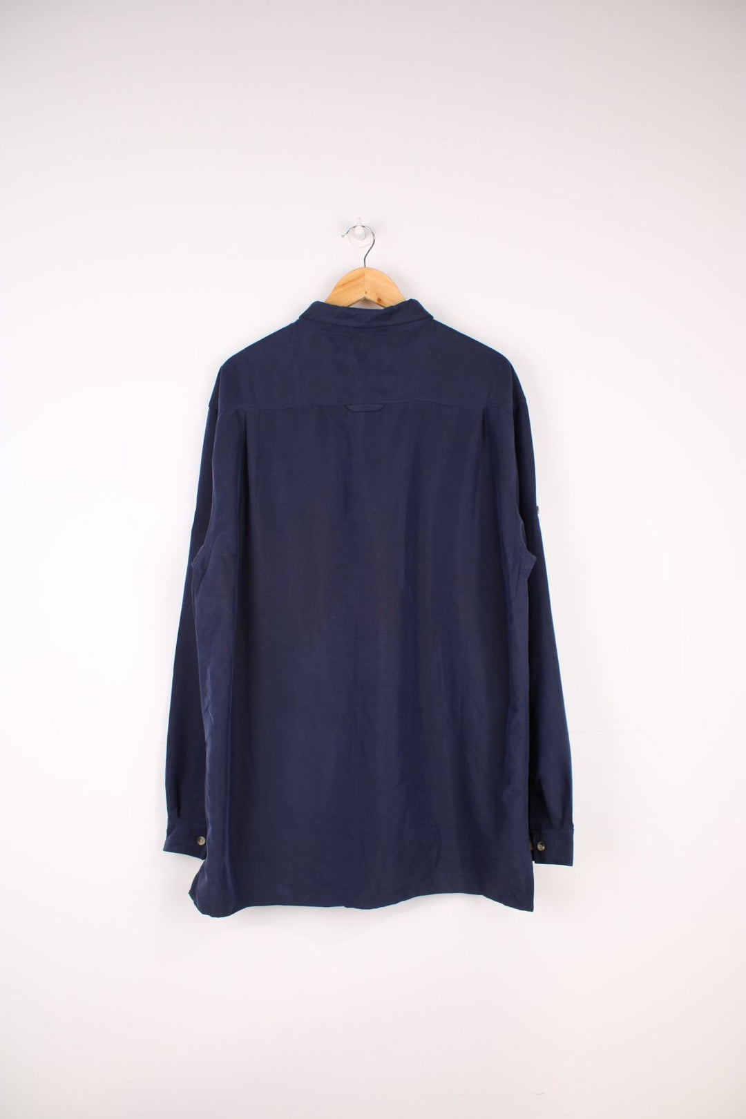 The North Face Long Sleeved Shirt in a navy blue colourway, button up and has a chest pocket with the logo embroidered on it.