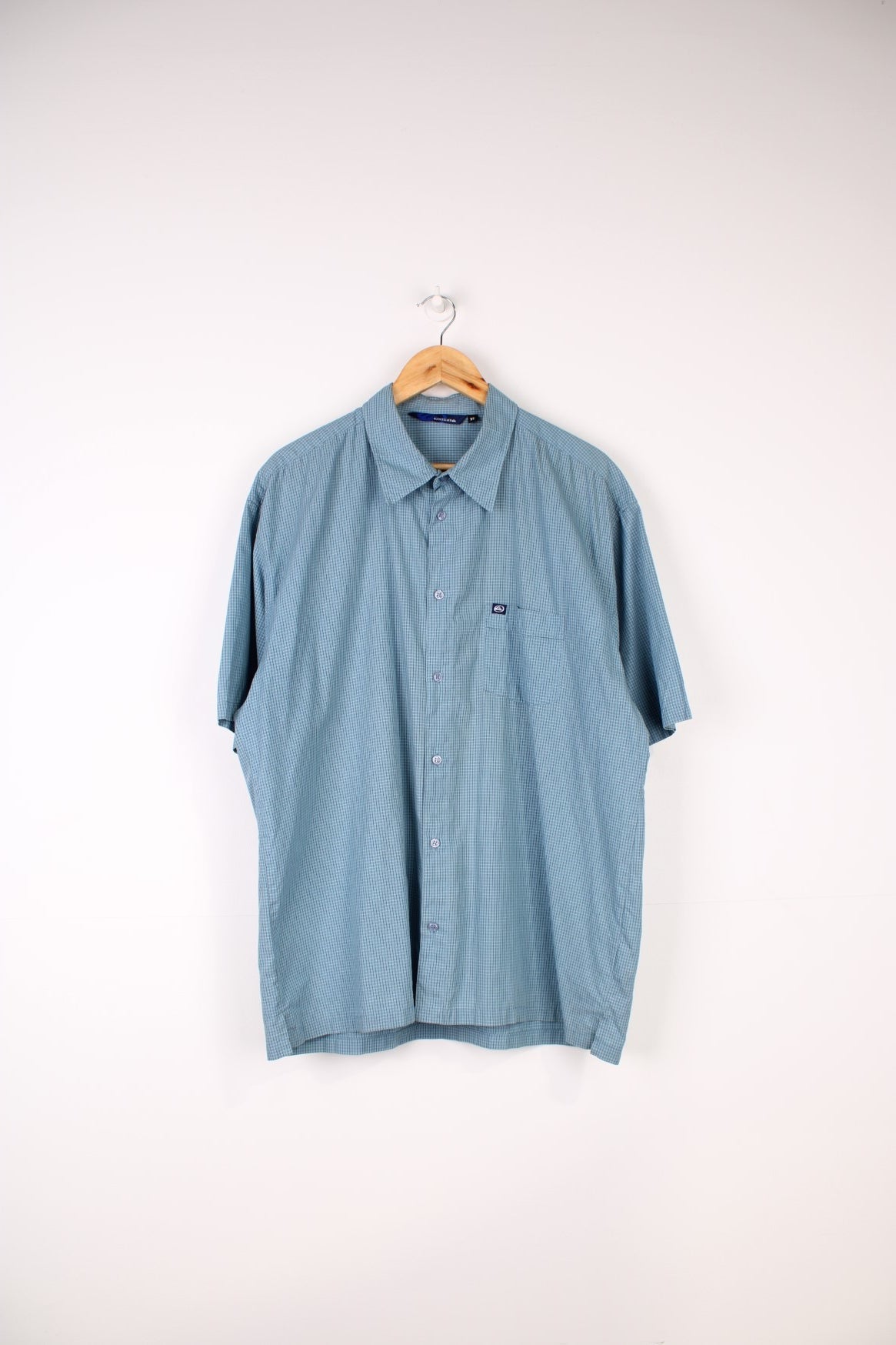 Quiksilver Shirt in a blue, black and white checkered colourway, button up and has a chest pocket with the logo embroidered on it. 