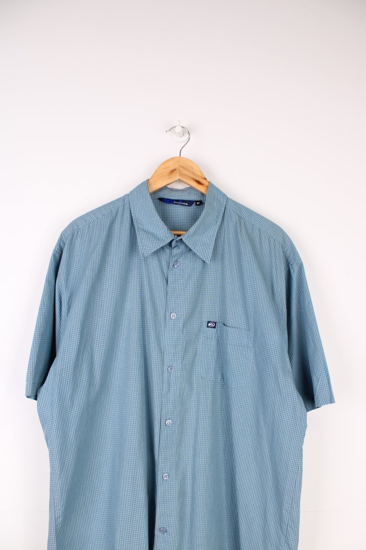 Quiksilver Shirt in a blue, black and white checkered colourway, button up and has a chest pocket with the logo embroidered on it. 