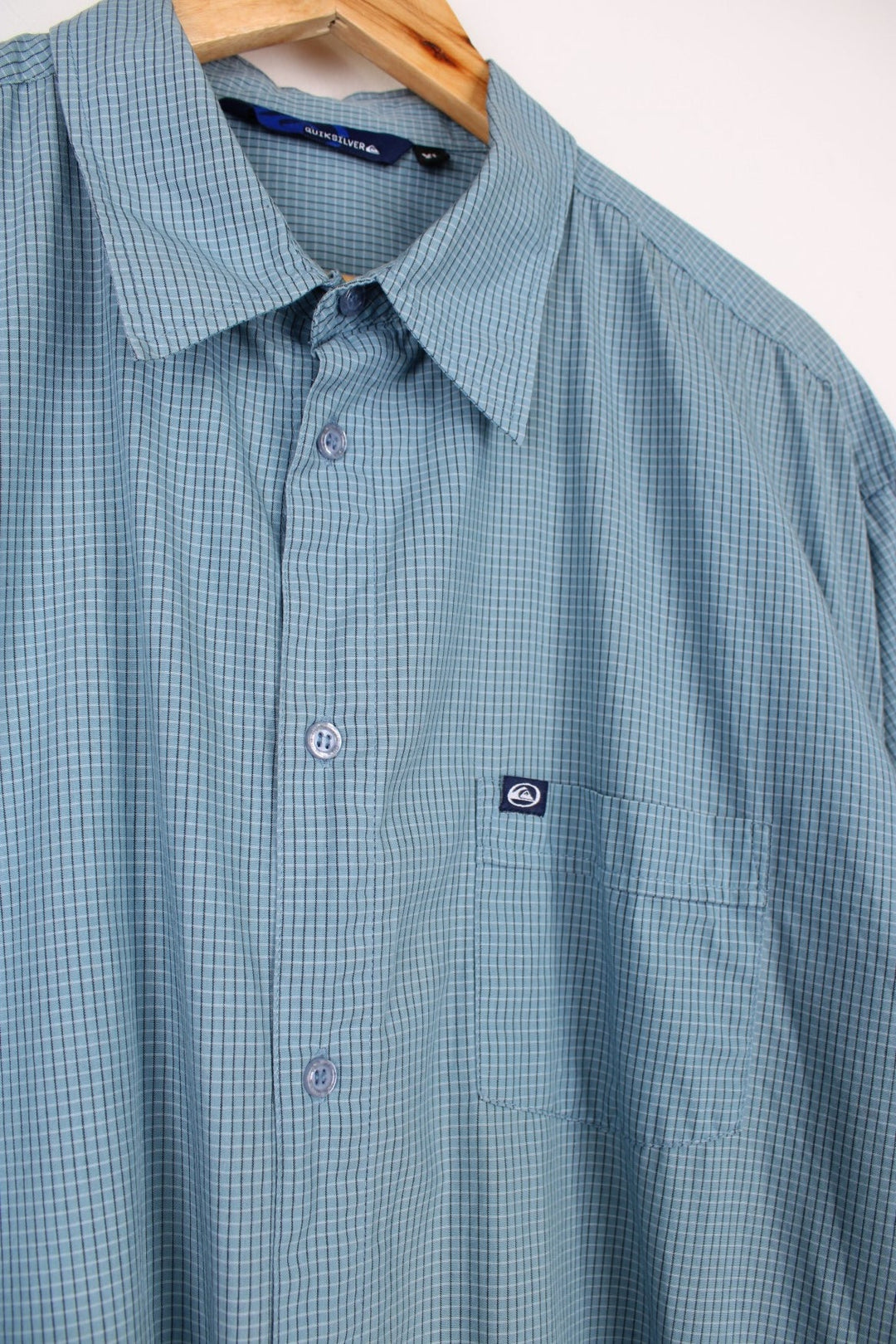 Quiksilver Shirt in a blue, black and white checkered colourway, button up and has a chest pocket with the logo embroidered on it. 