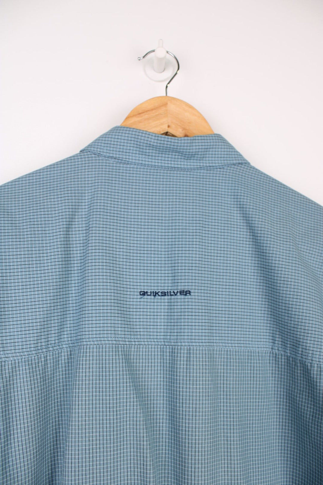 Quiksilver Shirt in a blue, black and white checkered colourway, button up and has a chest pocket with the logo embroidered on it. 