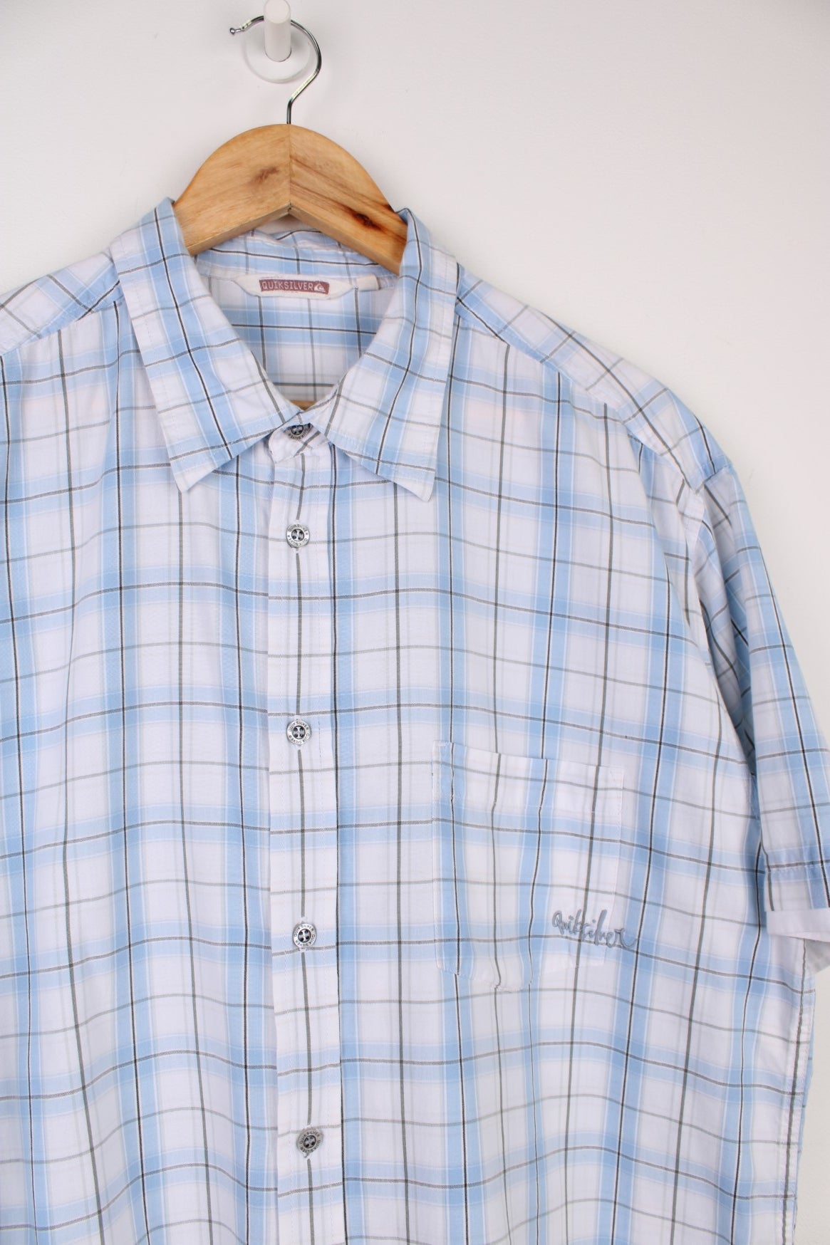 Quiksilver Plaid Shirt in a blue, black and white colourway, button up and has a chest pocket with the logo embroidered on it.