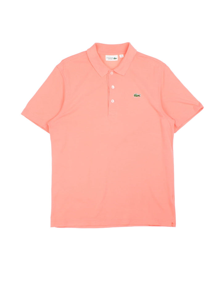 Vintage Lacoste Polo Shirt in a coral pink colourway with, logo embroidered on the front.