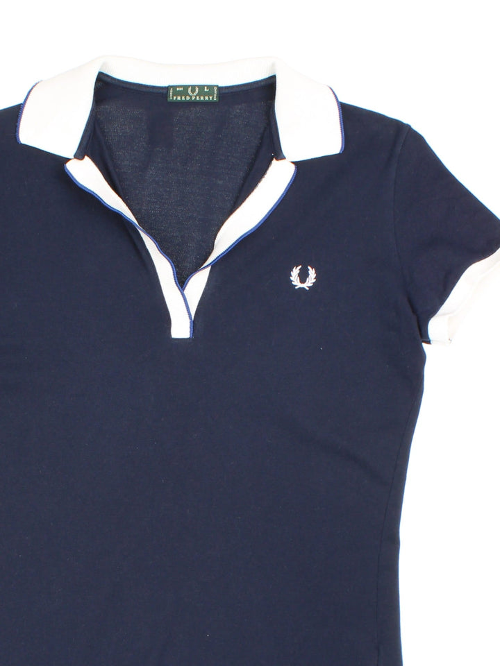 Vintage Fred Perry Polo Shirt in a blue colourway with contrast trim, and has the logo embroidered on the front.