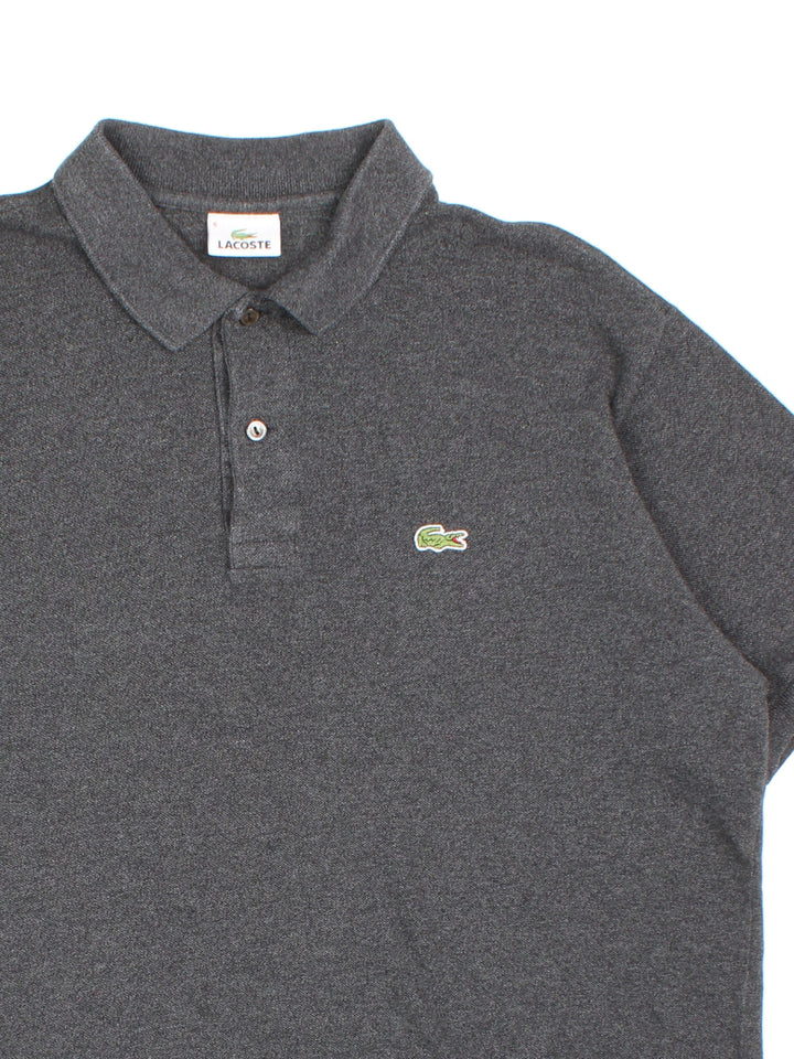 Vintage Lacoste Polo Shirt in a grey colourway and has the logo embroidered on the front.