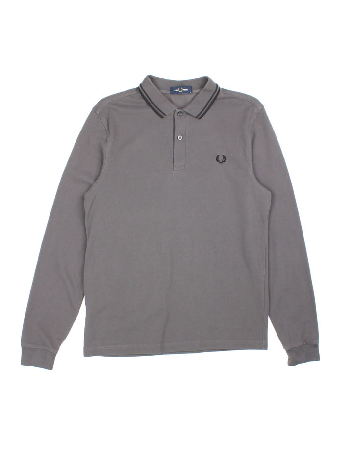 Vintage Fred Perry Long-sleeved Polo Shirt in a grey colourway and has the logo embroidered on the front.