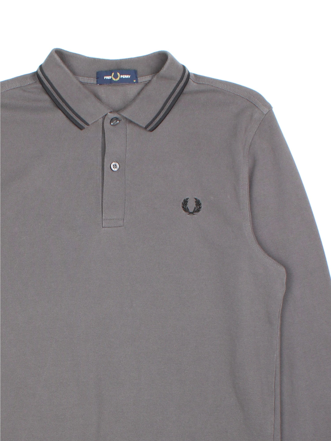 Vintage Fred Perry Long-sleeved Polo Shirt in a grey colourway and has the logo embroidered on the front.