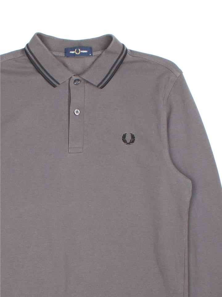 Vintage Fred Perry Long-sleeved Polo Shirt in a grey colourway and has the logo embroidered on the front.