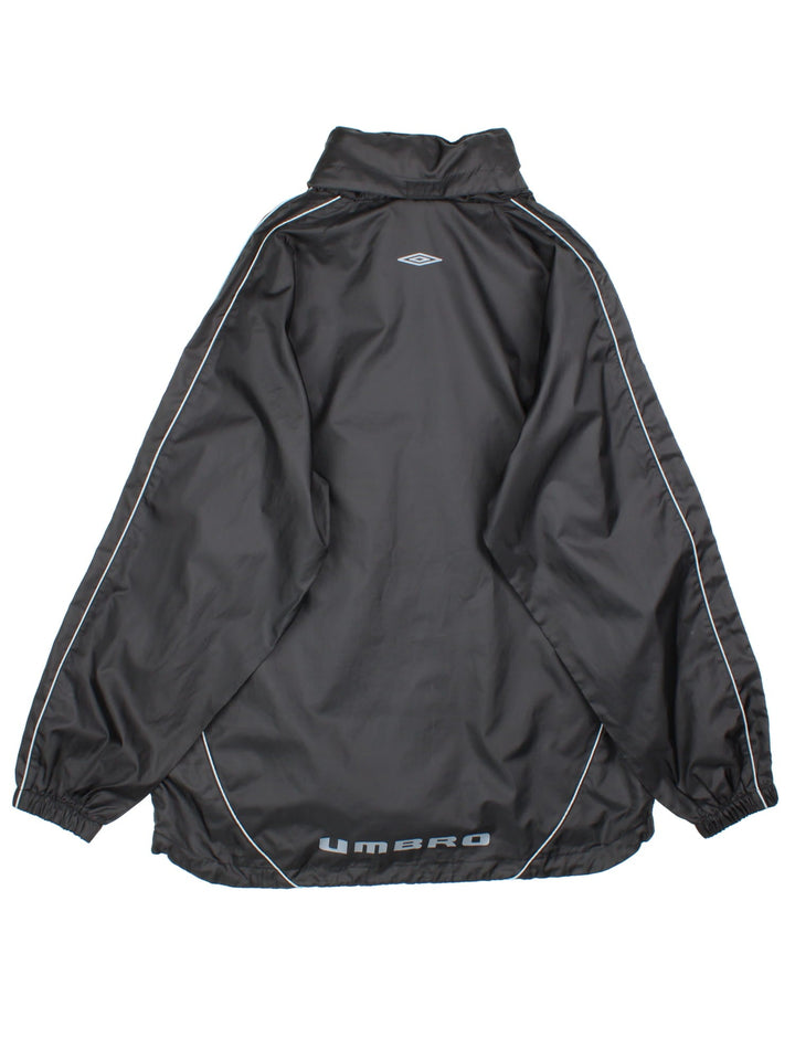 Vintage Umbro windbreaker in a black colourway, 1/4 zip fastening and has the logo printed on the front and back.