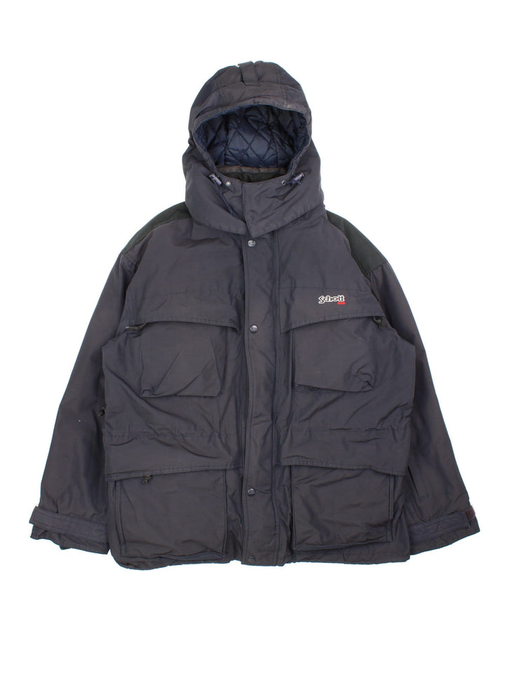 Vintage Schott 2 in 1 parka style coat in a black colourway, has padded detachable gilet, multiple pockets, hooded and has the branding embroidered on the front.