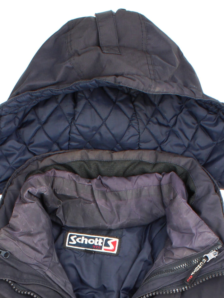 Vintage Schott 2 in 1 parka style coat in a black colourway, has padded detachable gilet, multiple pockets, hooded and has the branding embroidered on the front.