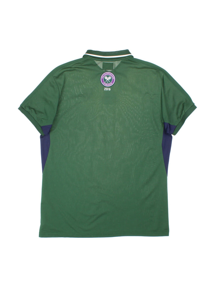 2019 Ralph Lauren Wimbledon Championship Polo Shirt in a green colourway with navy blue panels down the sides, and has the logo embroidered on the front and back.