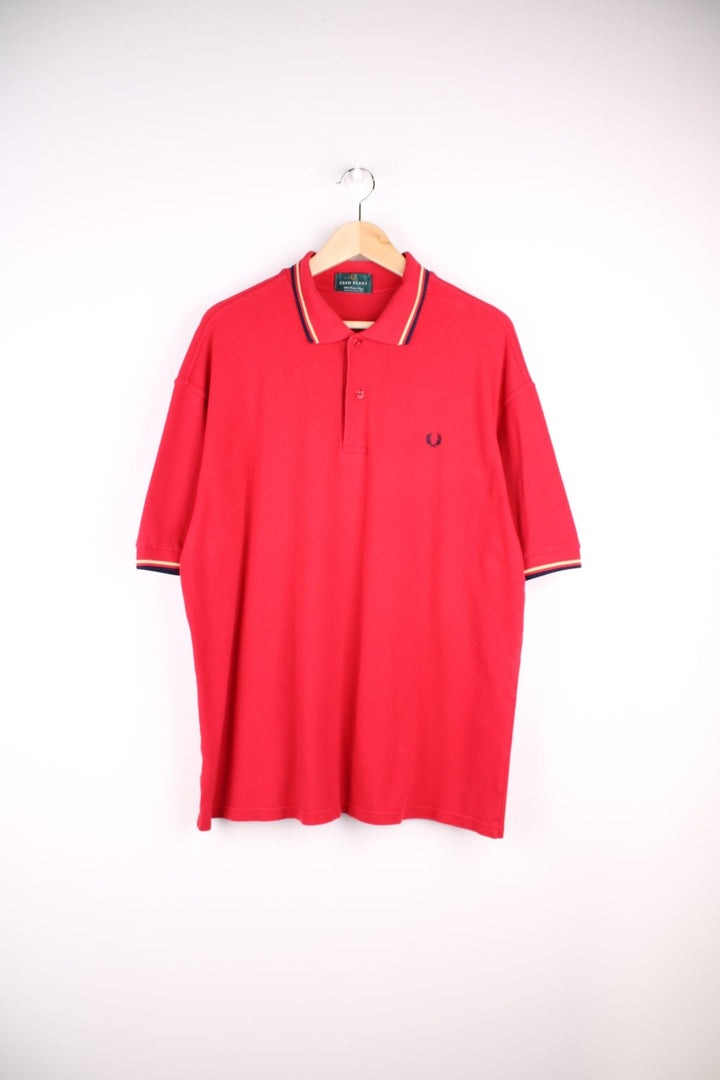 Fred Perry polo shirt in a red colourway with Fred Perry logo embroidered on front.