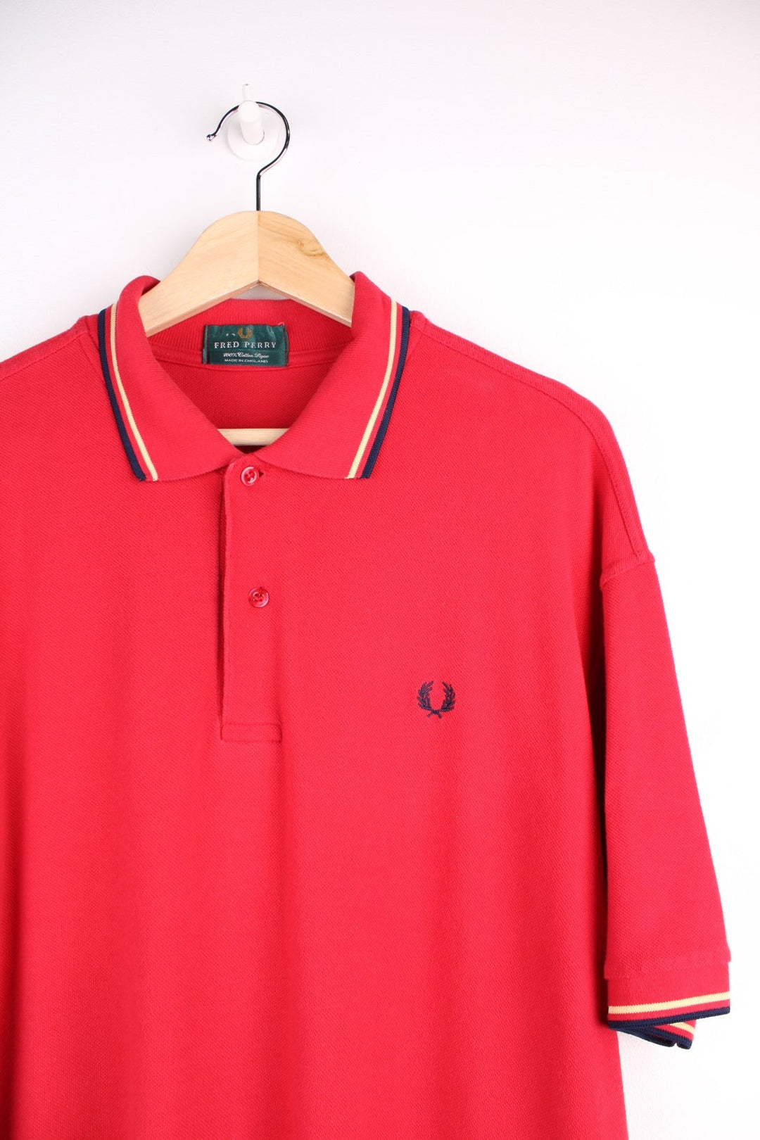 Fred Perry polo shirt in a red colourway with Fred Perry logo embroidered on front.