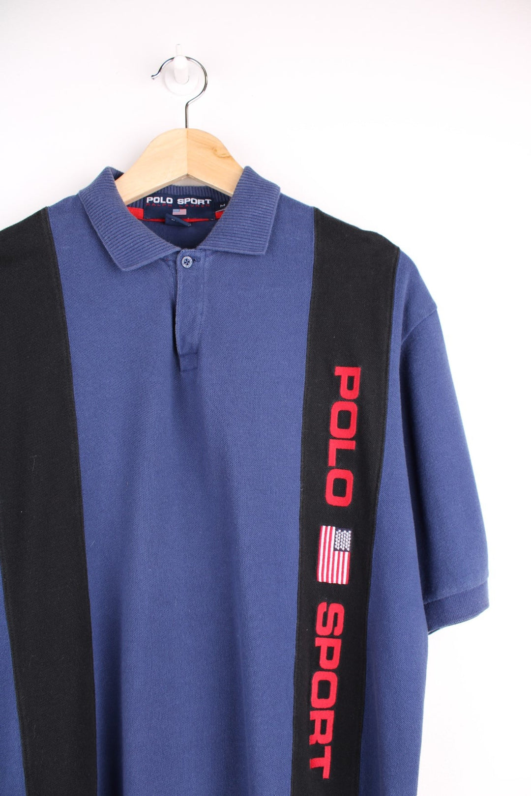 Ralph Lauren polo shirt in a blue colourway with two black stripes and Polo Sport logo on the front.