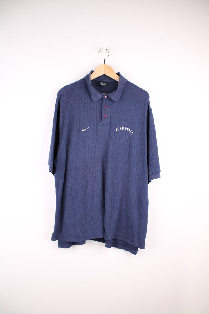 Nike Penn State polo shirt in a navy colourway with Nike logo and Penn State embroidered on the front.