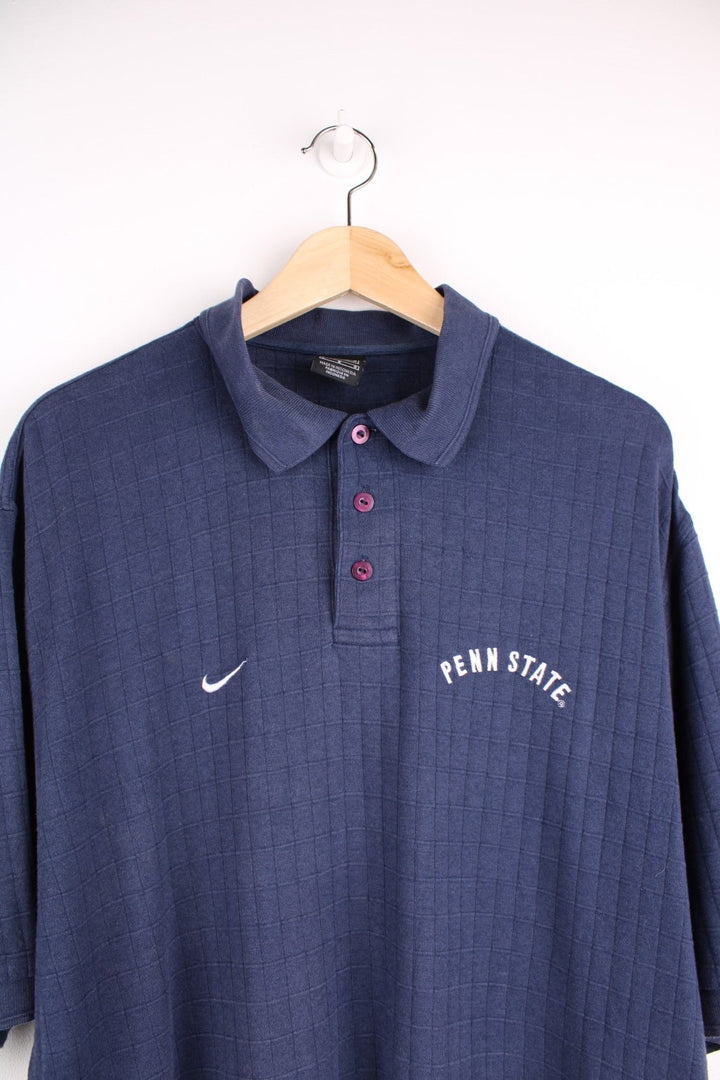 Nike Penn State polo shirt in a navy colourway with Nike logo and Penn State embroidered on the front.