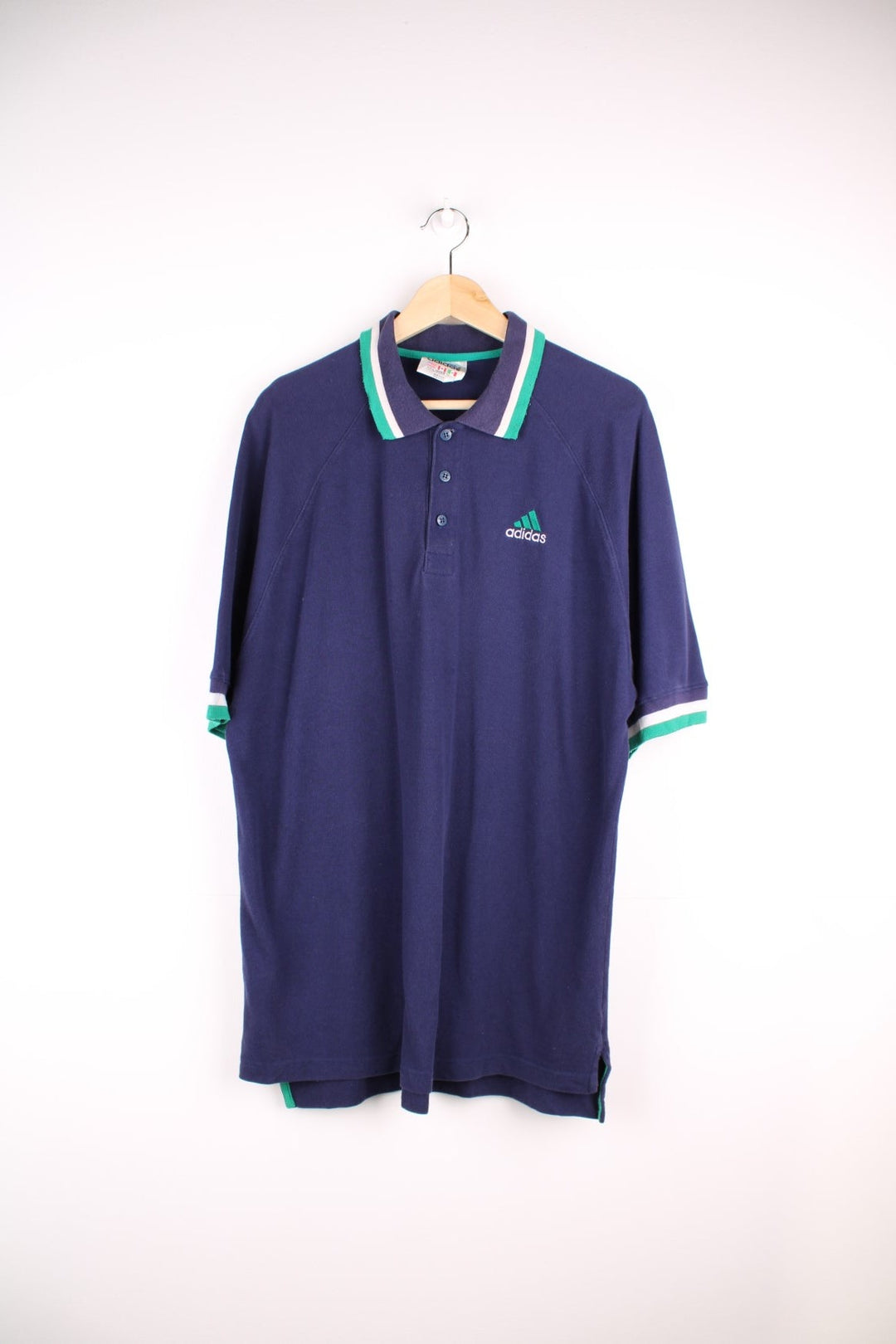 Adidas polo shirt in a navy colourway with striped collar detail and Adidas logo on the front.