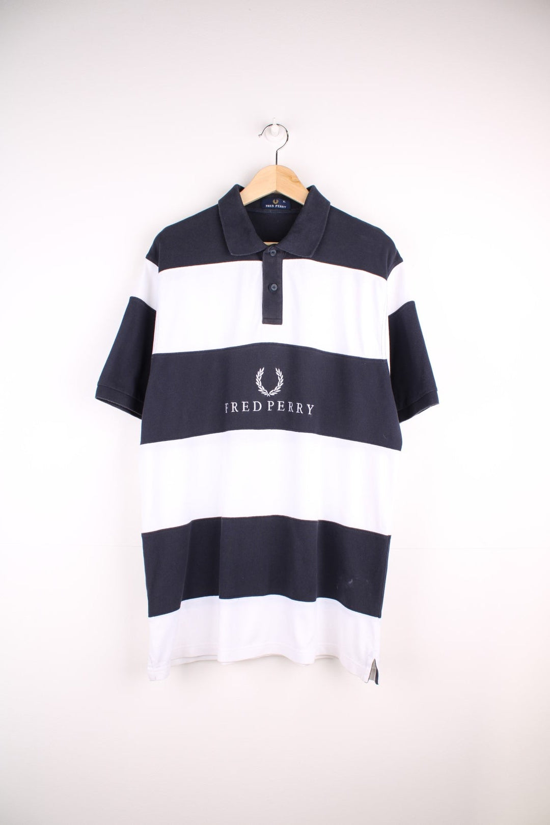 Fred Perry polo shirt in black and white stripe with Fred Perry on the front.