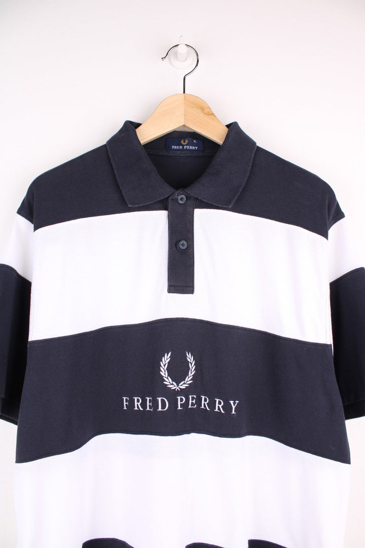 Fred Perry polo shirt in black and white stripe with Fred Perry on the front.