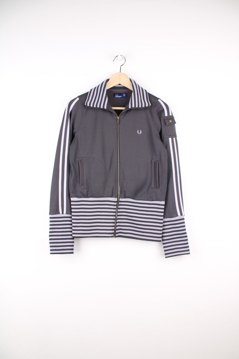 Vintage Fred Perry Tracksuit Top in a grey striped colourway, zip up with side pockets, and has the logo embroidered on the front.