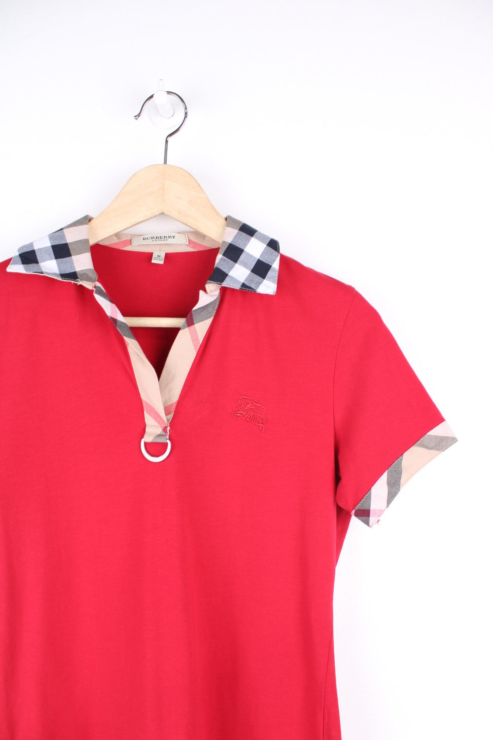 Burberry London Top in a red colourway with the nova check print on the collar and sleeves, and has the logo embroidered on the front.