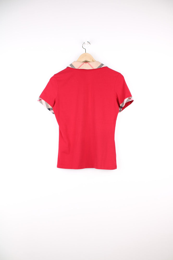 Burberry London Top in a red colourway with the nova check print on the collar and sleeves, and has the logo embroidered on the front.