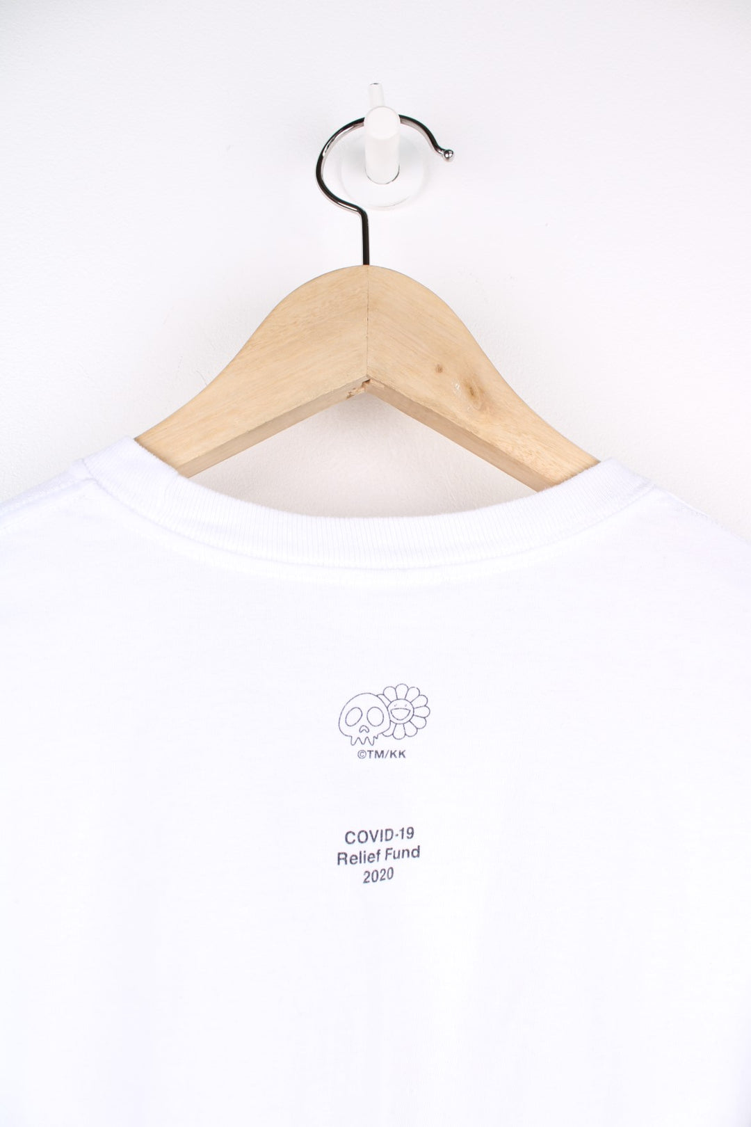 Supreme Murakami Relief Box Logo T-Shirt in a white colourway, has the supreme box logo with a floral emoji print going around, and also has 'Covid 19 Relief Fund 2020' printed on the back.