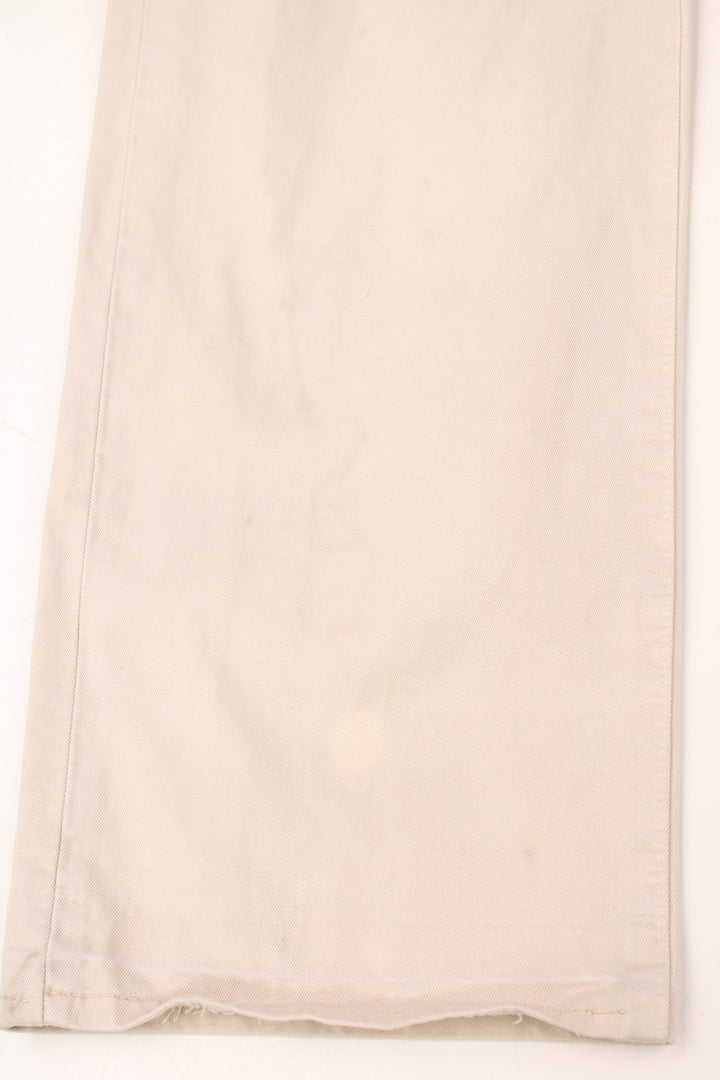 Stone Island made in Italy 100% cotton jeans/trousers in a cream colourway, features leather badge on the waistband and printed spell-out logo on the back pocket