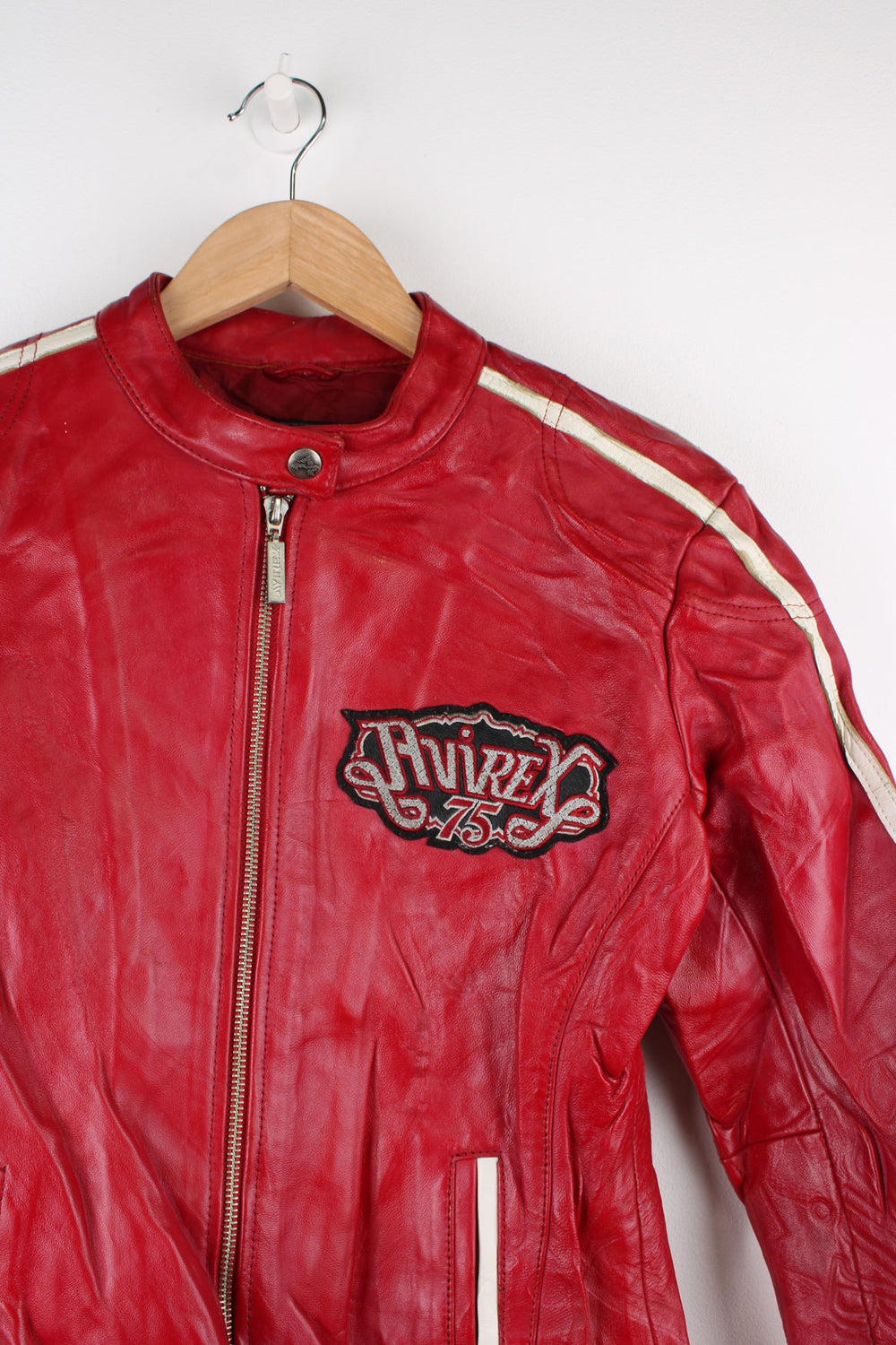 Vintage red leather Avirex zip through motorcycle jacket with white detailing and embroidered badges on the front/back.