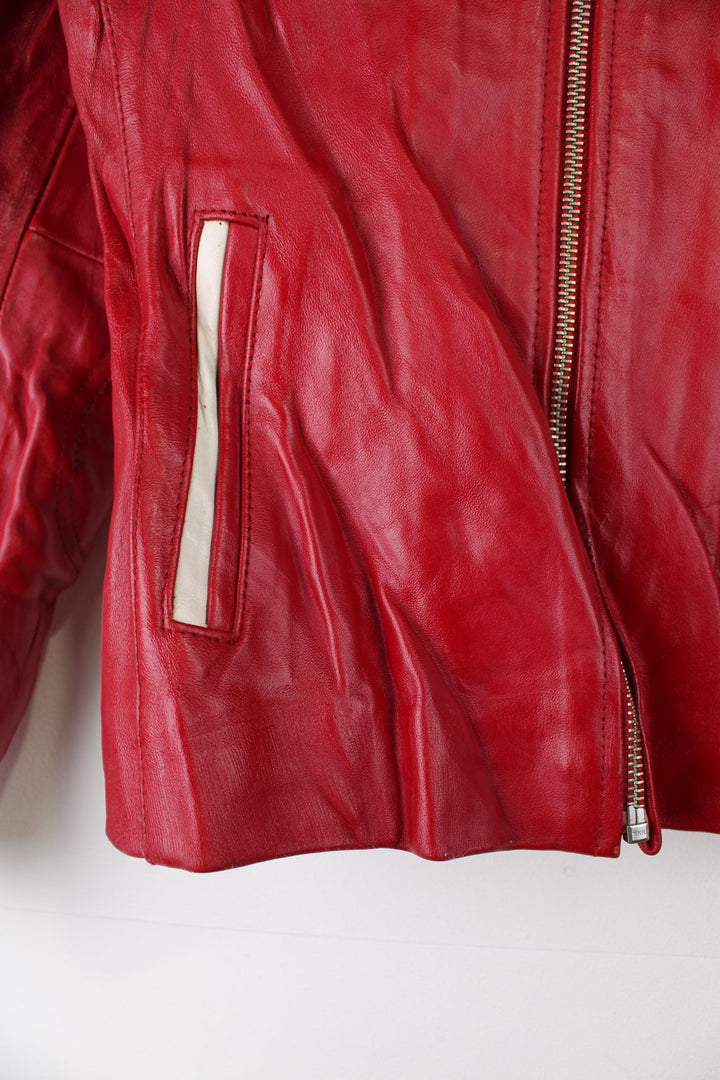 Vintage red leather Avirex zip through motorcycle jacket with white detailing and embroidered badges on the front/back.