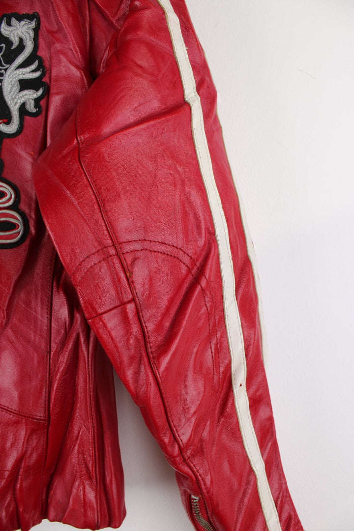 Vintage red leather Avirex zip through motorcycle jacket with white detailing and embroidered badges on the front/back.