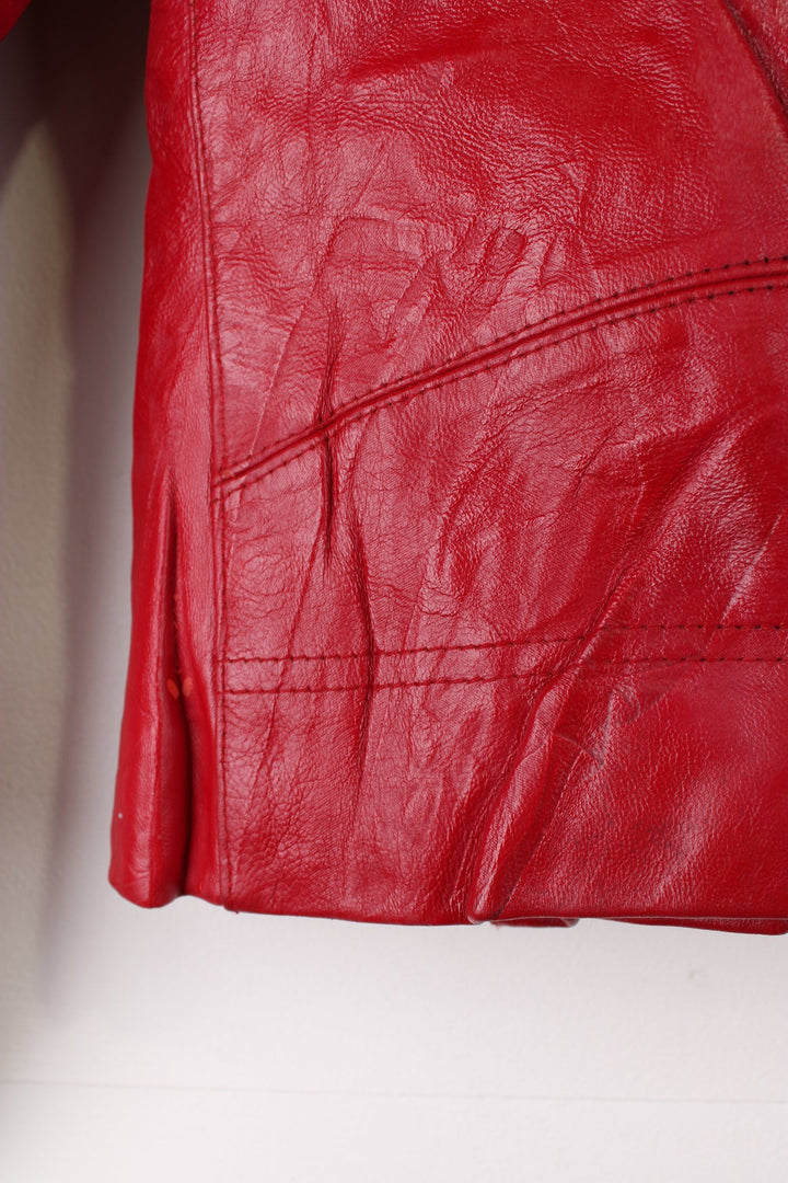 Vintage red leather Avirex zip through motorcycle jacket with white detailing and embroidered badges on the front/back.