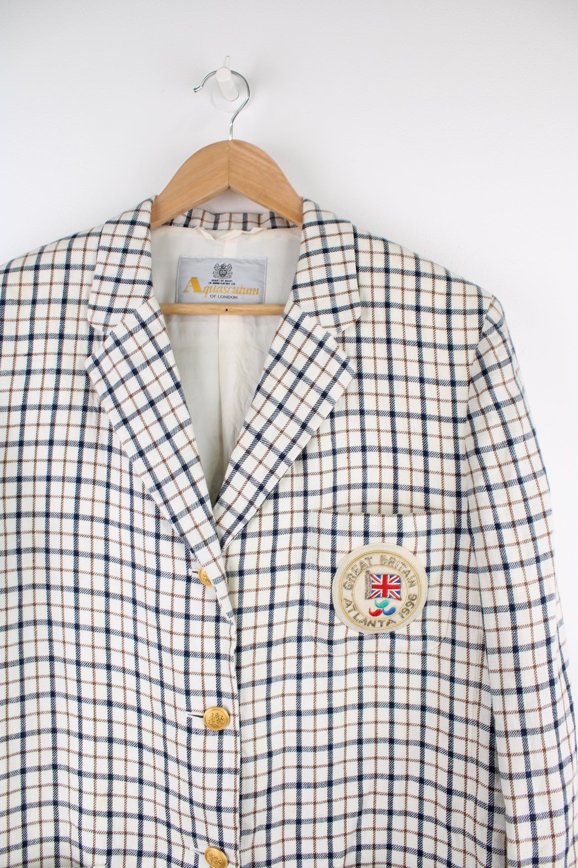 Vintage Aquascutum made in England linen blazer in a cream plaid pattern, features embellished badge on the pocket and golden buttons