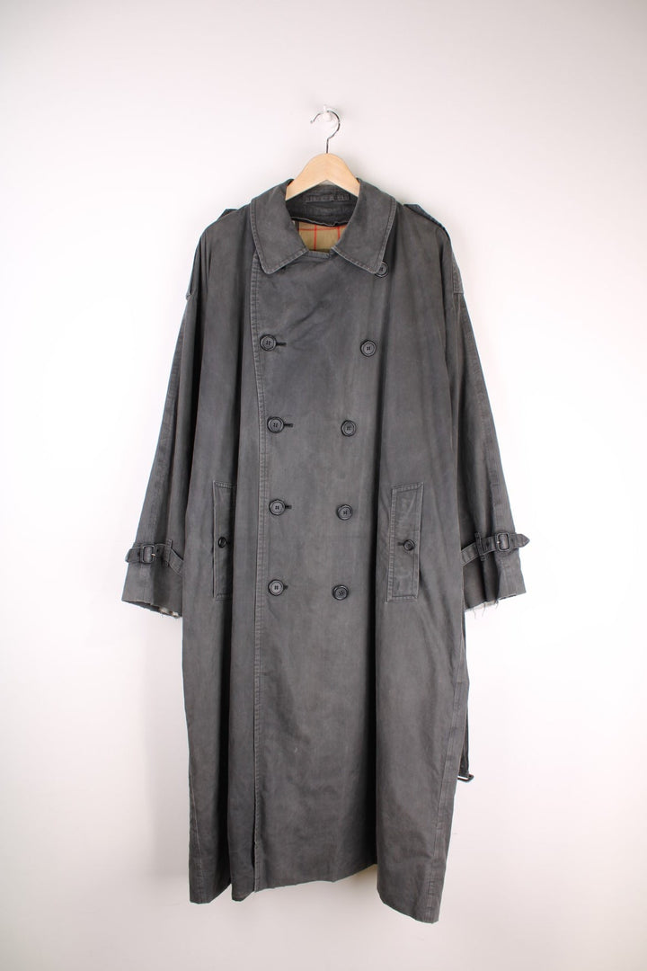 Vintage Burberry Trench Coat in a grey colourway, nova check lining, buttons up and has side pockets and a belt. 