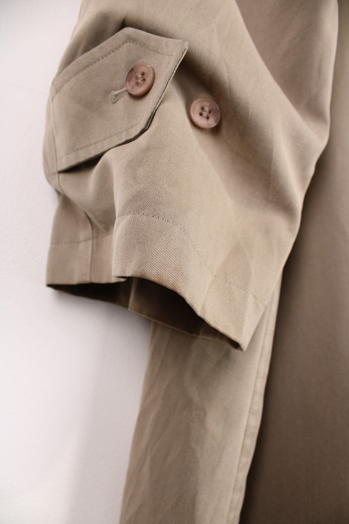 Vintage Burberry Trench Coat in a tan colourway, nova check lining, buttons up and has side pockets and a belt. 