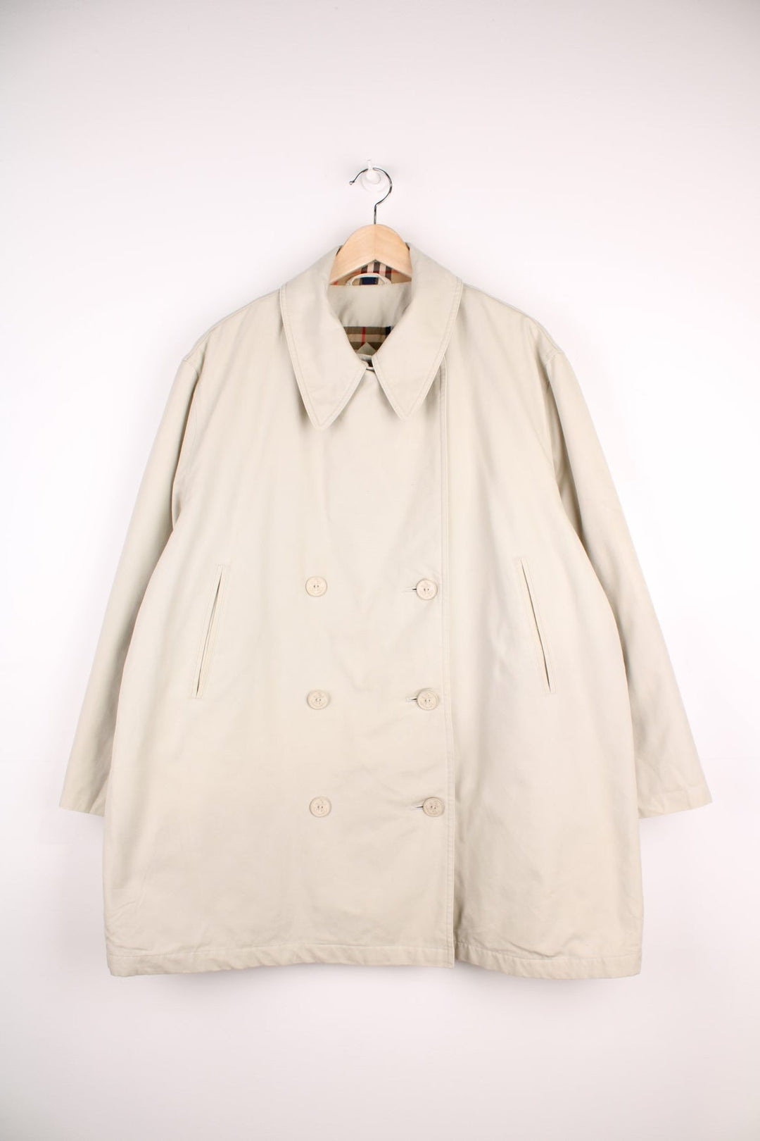 Vintage Burberry Trench Coat in a white colourway, nova check lining, buttons up and has side pockets. 