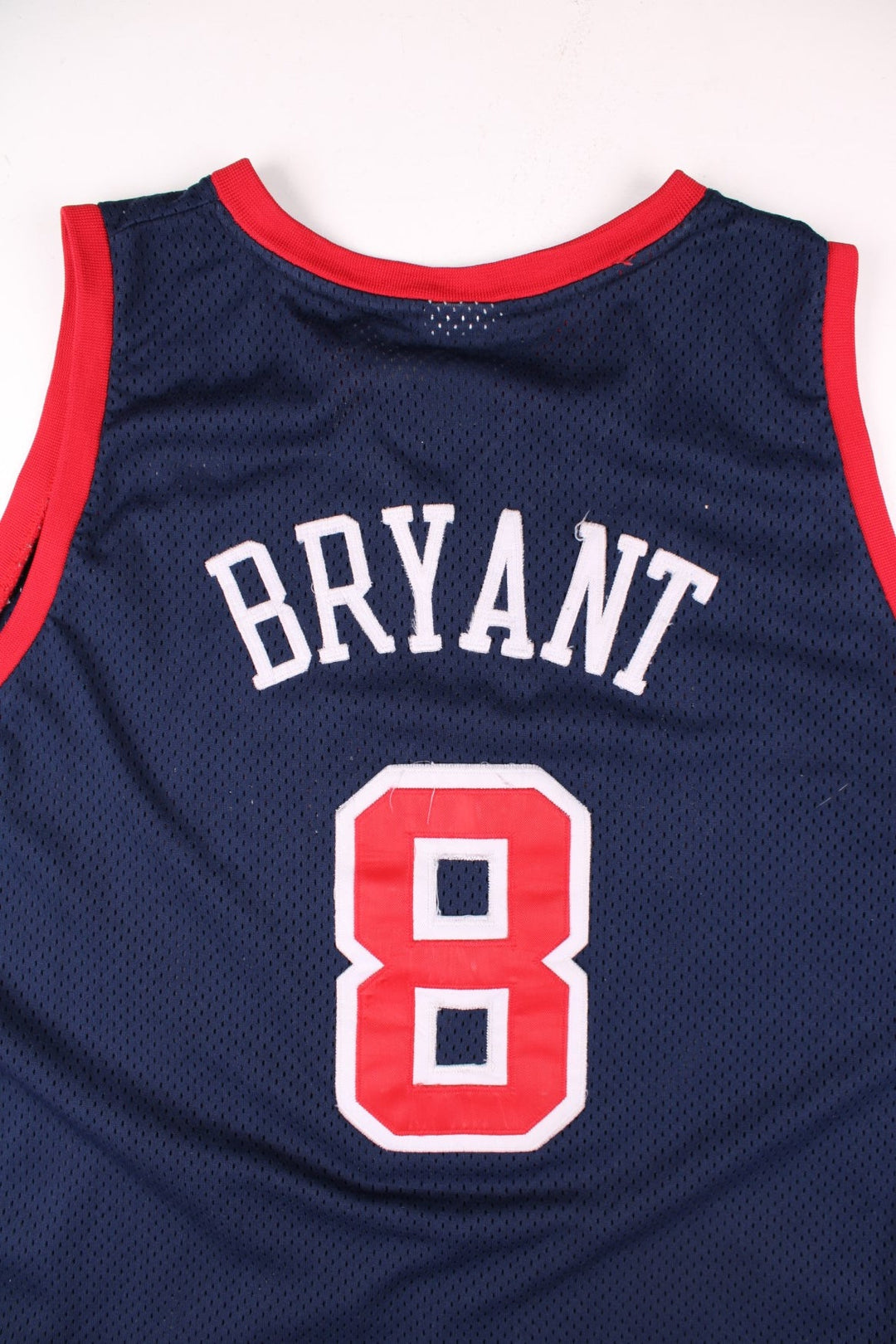 Vintage USA Dream Team Kobe Bryant Nike Basketball Jersey in a navy blue kit colourway, features embroidered logos and badge on the front, and on the back Bryant number 8.