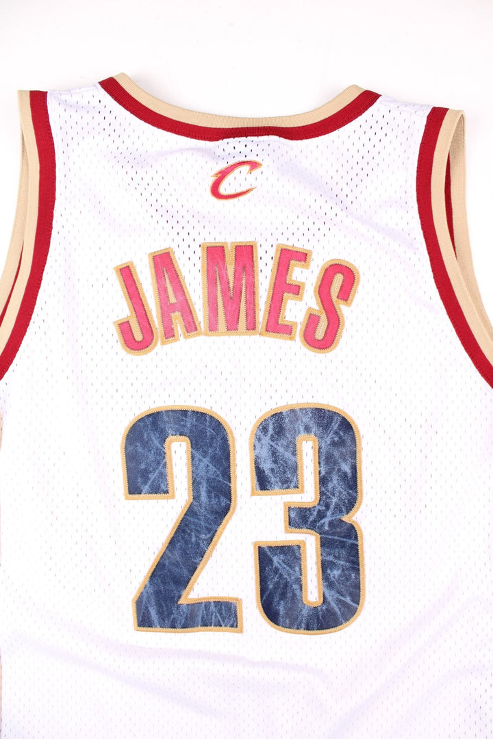 Cleveland Cavaliers Lerbon James NBA Basketball Jersey in the white, red and gold kit colourway, features embroidered logos and badge on the front, and James number 23 on the back.