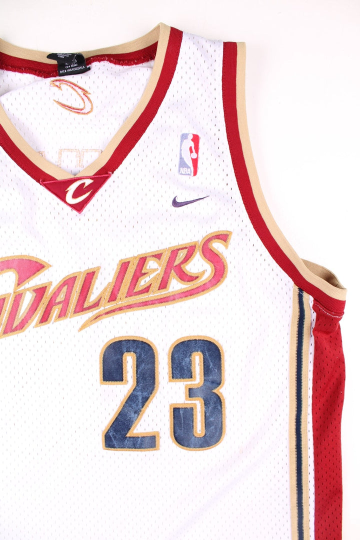 Cleveland Cavaliers Lerbon James NBA Basketball Jersey in the white, red and gold kit colourway, features embroidered logos and badge on the front, and James number 23 on the back.