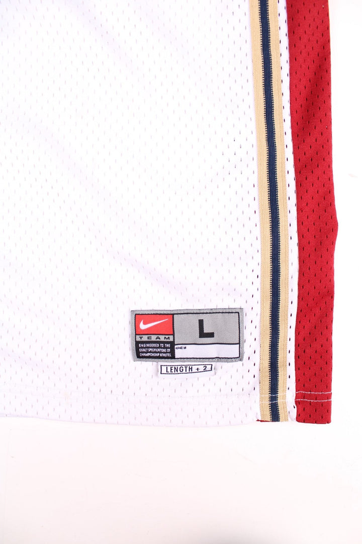 Cleveland Cavaliers Lerbon James NBA Basketball Jersey in the white, red and gold kit colourway, features embroidered logos and badge on the front, and James number 23 on the back.