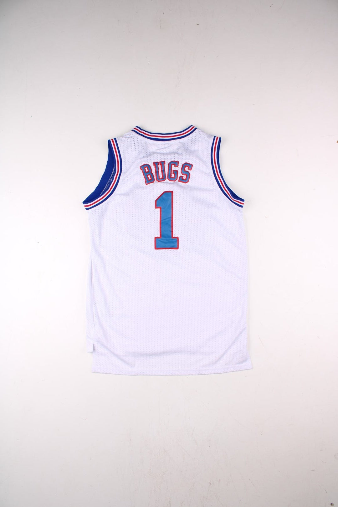 Looney Tune Space Jam Tunes Squad Champion Basketball Jersey in the white, red and blue kit colourway, features embroidered logos and badge on the front, and Buggs number 1 on the back.