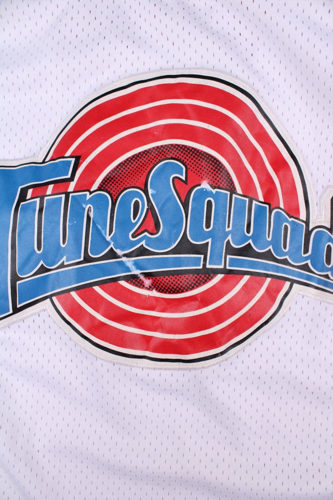 Looney Tune Space Jam Tunes Squad Champion Basketball Jersey in the white, red and blue kit colourway, features embroidered logos and badge on the front, and Buggs number 1 on the back.