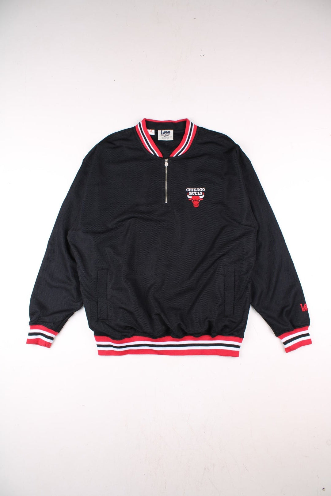 Vintage Chicago Bulls NBA Pullover Track Top in a black and red colourway, quarter zips up, has two side pockets, and features the team logo embroidered on the front.