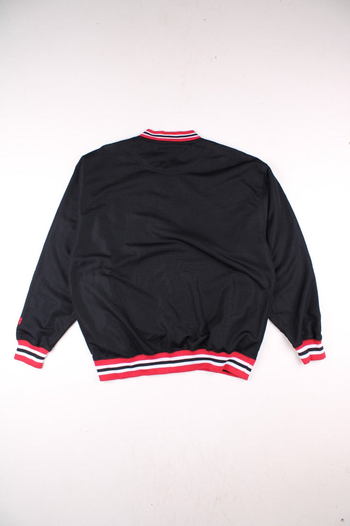 Vintage Chicago Bulls NBA Pullover Track Top in a black and red colourway, quarter zips up, has two side pockets, and features the team logo embroidered on the front.