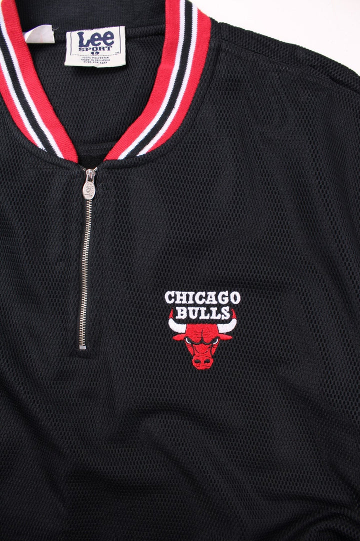 Vintage Chicago Bulls NBA Pullover Track Top in a black and red colourway, quarter zips up, has two side pockets, and features the team logo embroidered on the front.