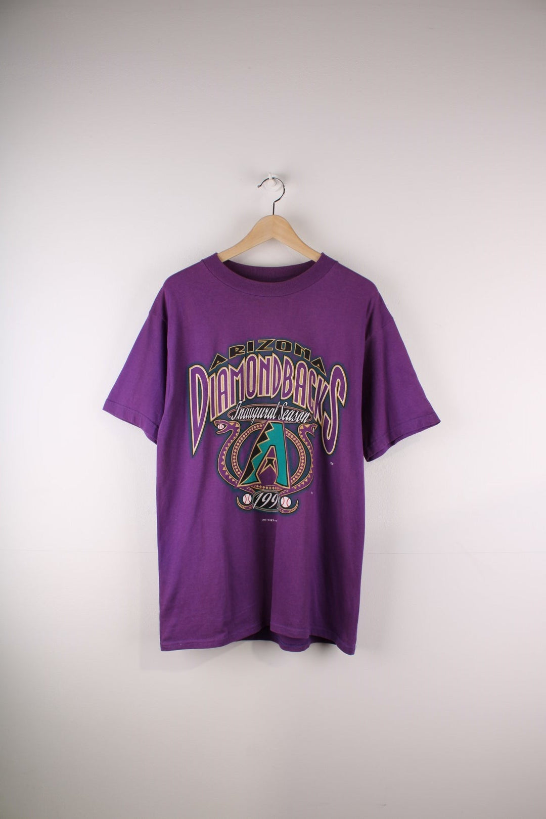 Vintage Arizona Diamondbacks baseball t-shirt in purple with a front graphic featuring snakes and baseballs.